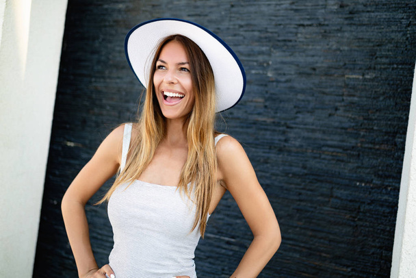 Portrait of a beautiful young woman in hat. Laughing girl. Summer time - Фото, зображення