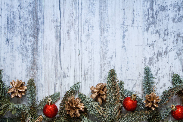 Top view fir branch with Christmas decorations on white wooden background with copy space for text, soft focus - 写真・画像