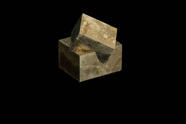 Macro mineral stone Pyrite on a black background - Photo, image