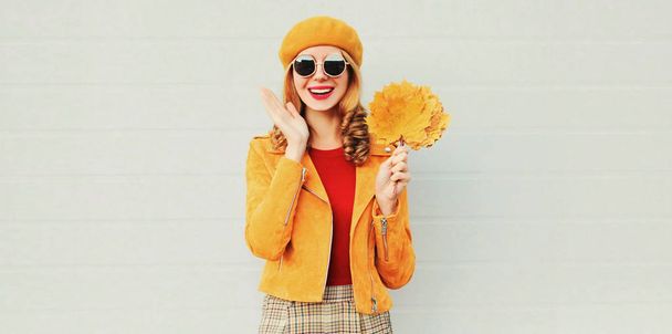 Autumn season! happy surprised woman with yellow maple leaves in - Photo, Image