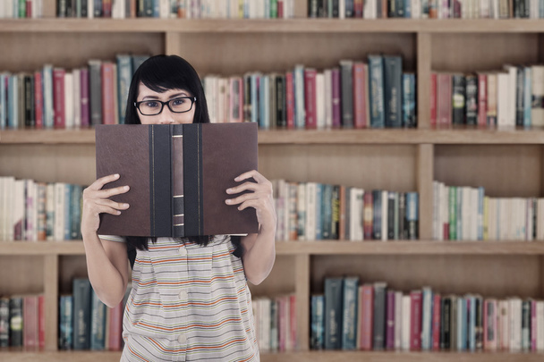 Asian female student read book at library - Valokuva, kuva