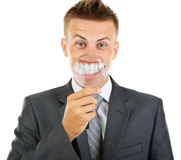Businessman with magnifying glass zooming on his smile - Foto, Imagem