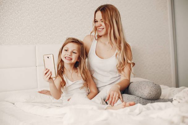 mother with cute blond daughter - Фото, изображение