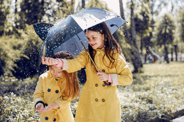 Cute kids plaiyng on a rainy day - Foto, afbeelding