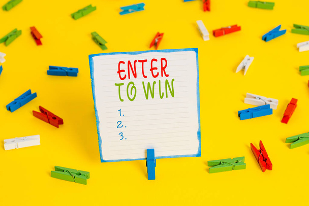 Handwriting text Enter To Win. Concept meaning exchanging something value for prize or chance of winning Colored clothespin papers empty reminder yellow floor background office. - Photo, Image