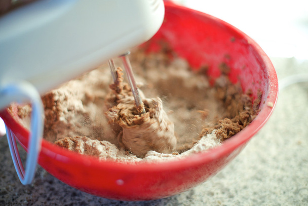 Hand mixer mixes cake ingredients, close up - Photo, Image