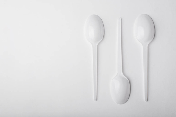 Three plastic spoon on white background. - Zdjęcie, obraz