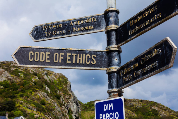Word writing text Code Of Ethics. Business concept for basic guide for professional conduct and imposes duties Road sign on the crossroads with blue cloudy sky in the background. - Photo, Image
