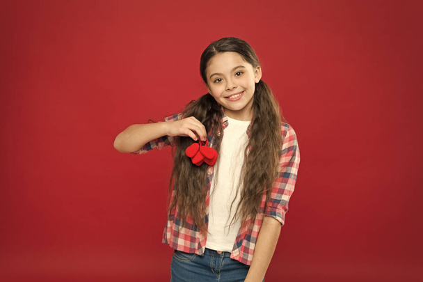 February holiday. Enjoying happy moment. Childrens day. Love and family. Childhood happiness. Happy child with red decorative heart. happy little girl. Valentines day. Small girl with cute look - Фото, изображение