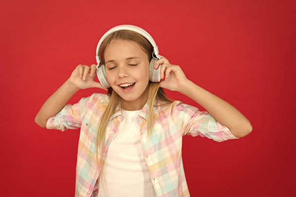 Girl child listen music modern headphones. Get music account subscription. Enjoy music concept. Music always with me. Leisure concept. Little girl listen song headphones. Online radio station channel - Fotó, kép