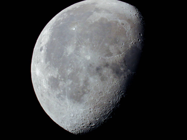 a very dense close-up of a decreasing moon in the night sky - Photo, Image