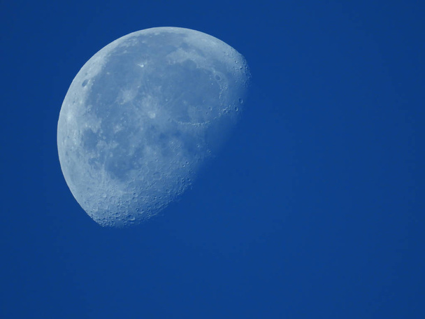 a very dense close-up of a decreasing moon in the morning sky - Photo, Image