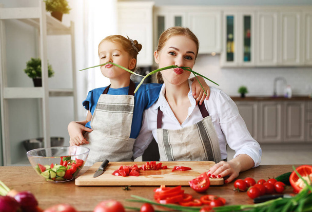 happy family mother with child girl preparing vegetable salad  - Photo, Image