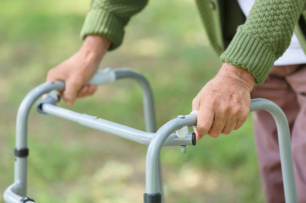 Elderly man with walking frame in park, closeup - Photo, Image