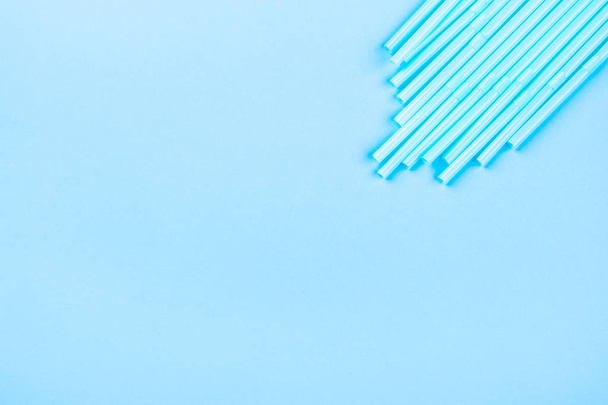 Blue cocktail straws on a color background. - Photo, Image