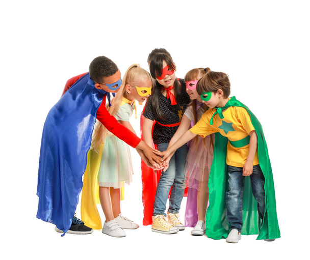 Cute little children dressed as superheroes on white background - Foto, afbeelding