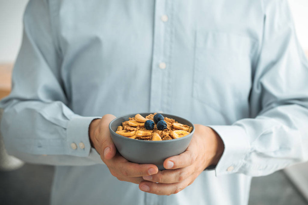 Healthy breakfast variety. Granola with fruit and seeds. Man with breakfast - Fotoğraf, Görsel