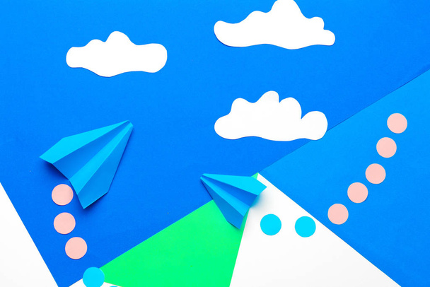 Paper plane  on a blue background with clouds - Fotó, kép