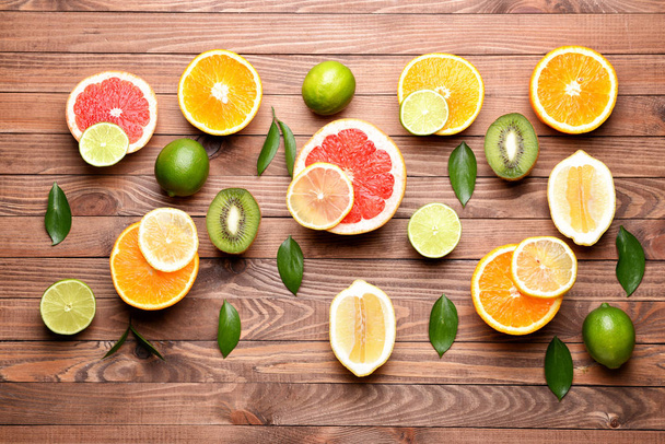 Different fresh fruits on wooden background - Photo, Image
