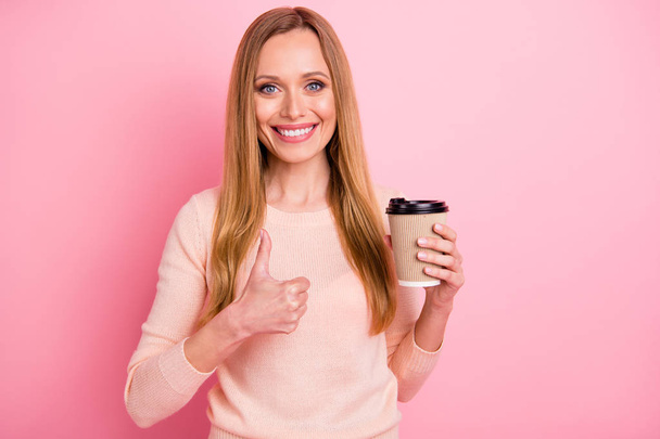 Portrait of lovely pretty girl hold hand latte feel glad adverts isolated over pink background - Photo, image