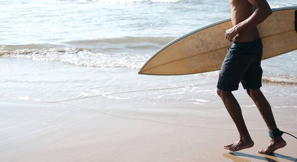Man Surfer Sitting at Surfboard on Sand Beach - Foto, afbeelding