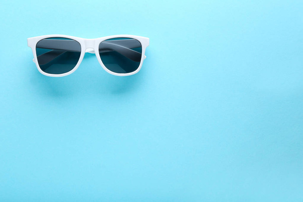 Modern sunglasses on blue background - Φωτογραφία, εικόνα