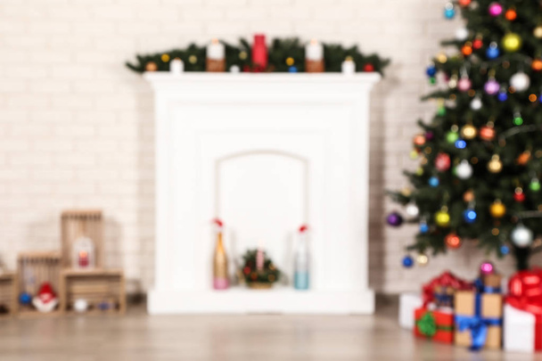 Blurred background of decorated fireplace near christmas tree - Zdjęcie, obraz