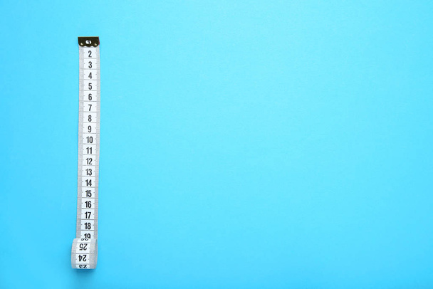White measuring tape on blue background - Фото, зображення