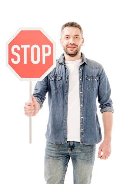 front view of bearded man man in denim shirt holding stop sign isolated on white - Valokuva, kuva
