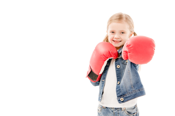 front view of smiling kid in red boxing gloves isolated on white - Foto, immagini