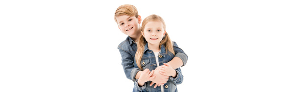 panoramic shot of happy kids embracing and looking at camera isolated on white - Photo, Image