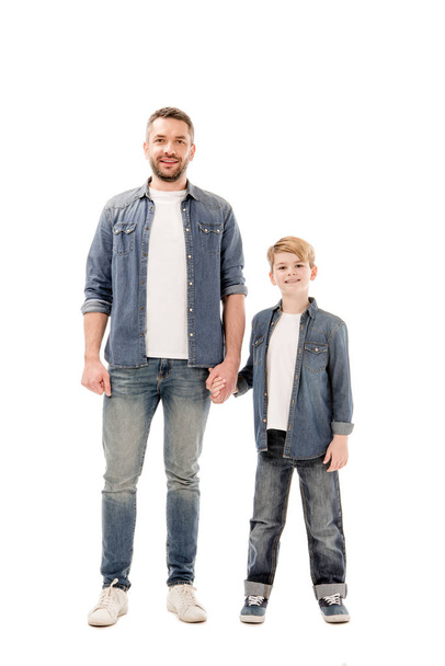 full length view of smiling son and father holding hands isolated on white - Φωτογραφία, εικόνα