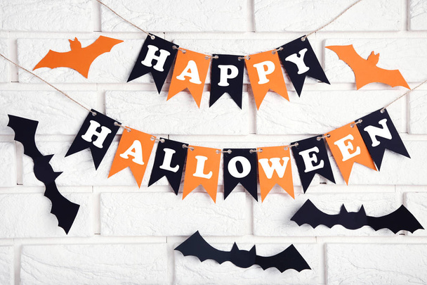 Paper halloween decorations on brick wall background - Zdjęcie, obraz