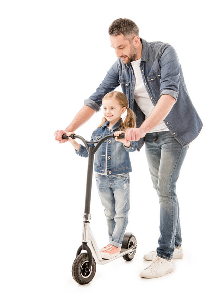 full length view of smiling dad and daughter with scooter isolated on white - Foto, Imagen
