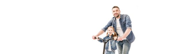 panoramic shot of smiling dad and daughter with scooter isolated on white - Photo, Image