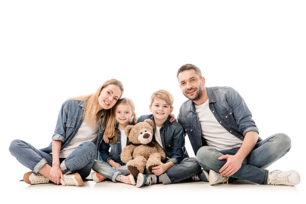 happy family in jeans with teddy bear sitting isolated on white - Foto, Bild