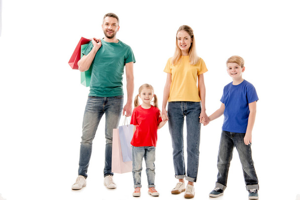 full length view of smiling family with shopping bags isolated on white - Фото, изображение