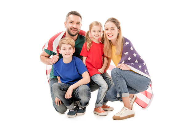 smiling family with american flag looking at camera isolated on white - Фото, зображення