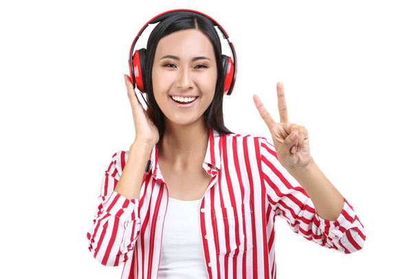 Beautiful woman with headphones on white background - 写真・画像