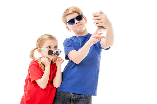 two kids in sunglasses taking selfie isolated on white - Foto, Imagem