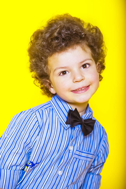 A kid portrait with curly hair on studio - Foto, Imagen