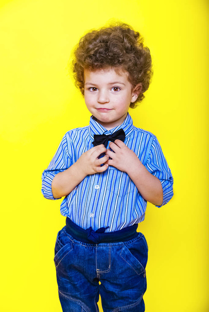 A kid portrait with curly hair on studio - Zdjęcie, obraz