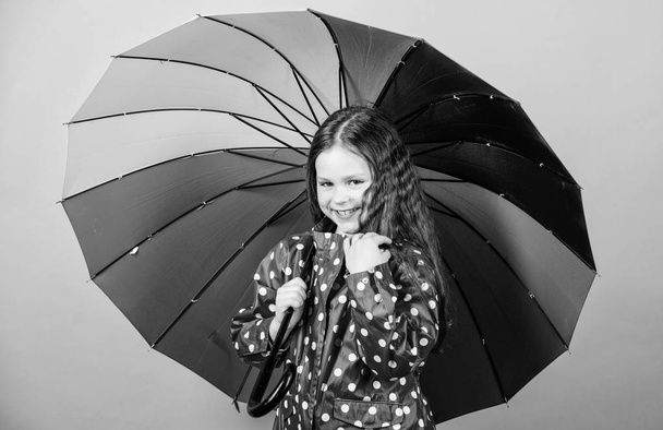 cheerful hipster child in positive mood. rain protection. Rainbow. happy small girl with colorful umbrella. Small girl in raincoat. autumn fashion. Feeling the nature. So beautiful - Фото, зображення