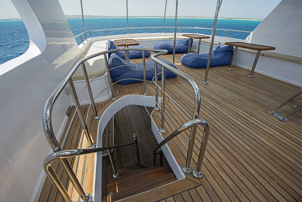 Table and chairs on deck of a luxury motor yacht - Photo, Image