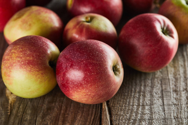 ripe juicy apples on brown wooden surface - Zdjęcie, obraz