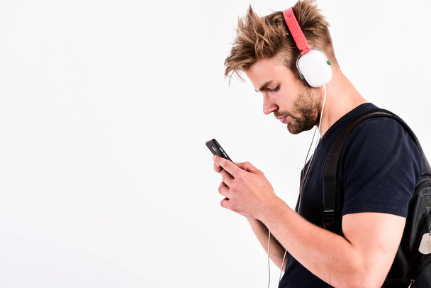 Music gadget. Musical accessory gadgets. Man listen music online headphones and smartphone. Modern technology. Music application concept. Mp3 player concept. Enjoy perfect music sound headphones - Fotografie, Obrázek