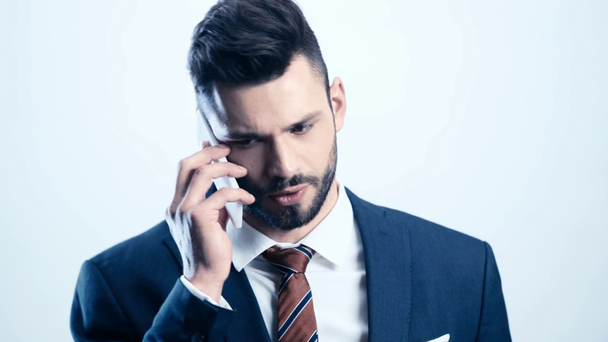 bearded man in suit talking on smartphone on white  - 映像、動画