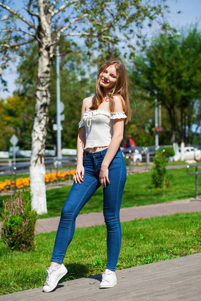 Young blonde business woman in blue jeans and white shirt - Valokuva, kuva