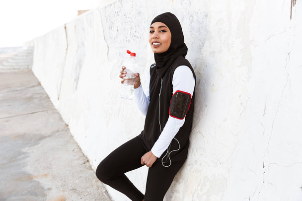 Attractive muslim sportswoman wearing hijab outdoors, - Fotoğraf, Görsel
