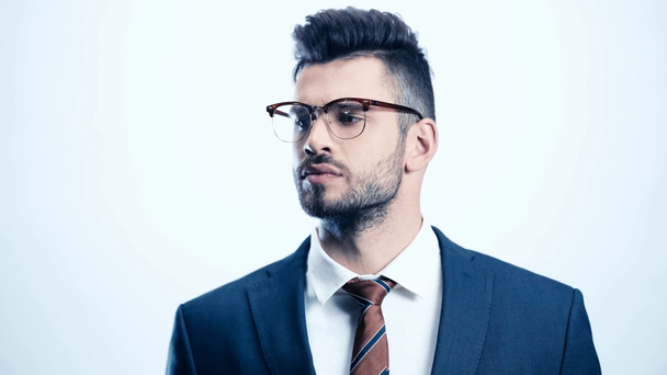 successful man in glasses touching tie on white  - Video, Çekim